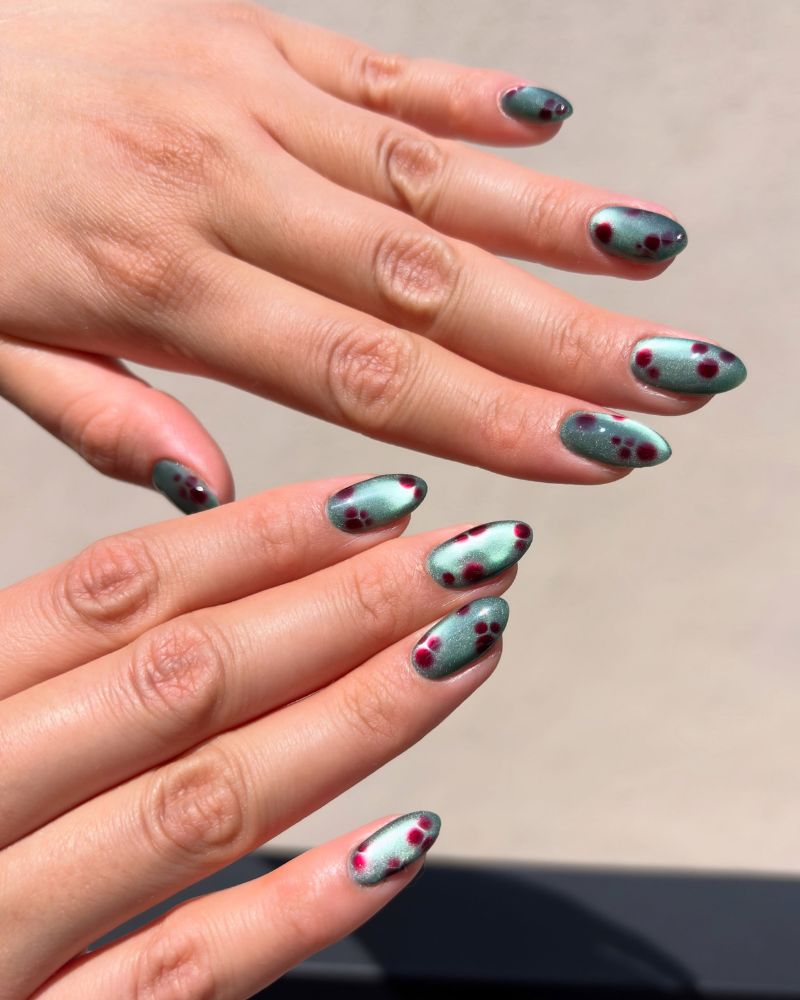 sage green jelly nails with dark crimson blooming gel dots