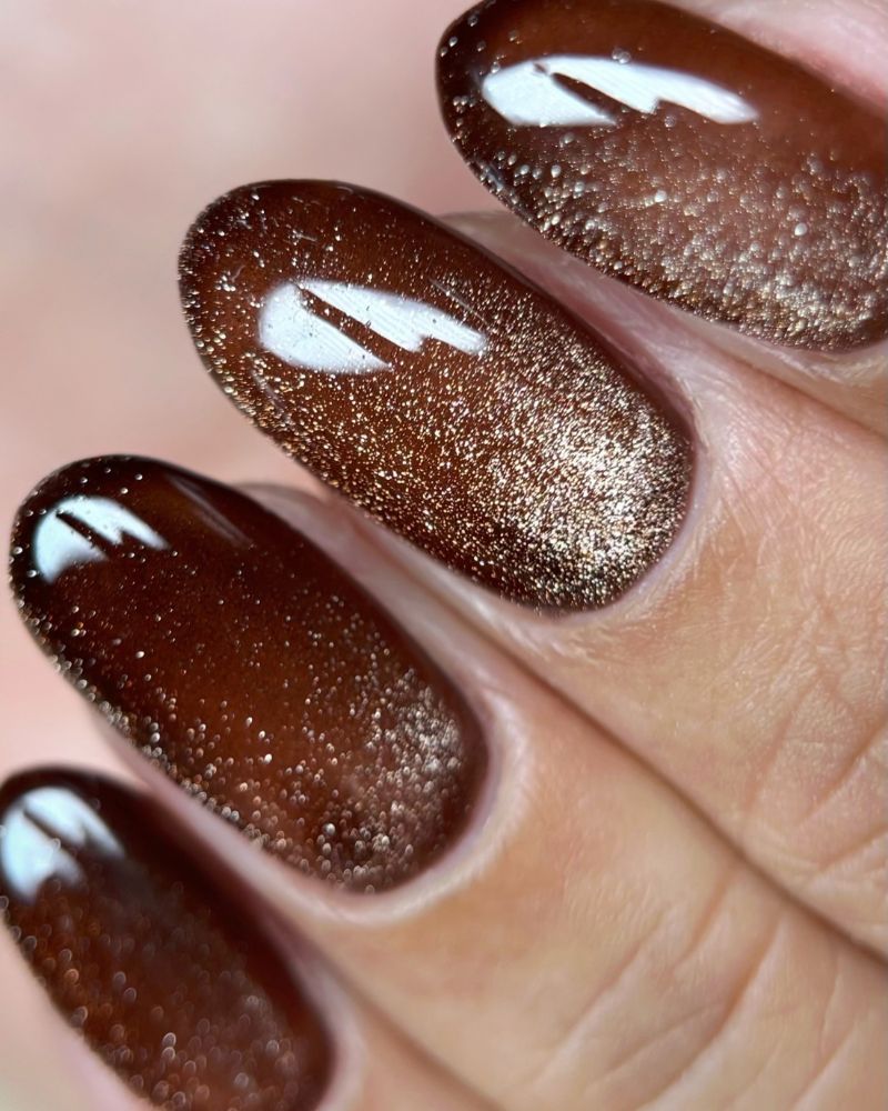 close up macro dark chocolate brown almond nails with extremely dense copper bronze micro shimmer throughout sandy texture