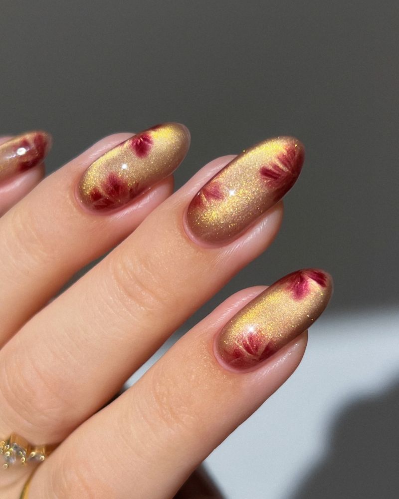 fall jelly nails golden amber glitter base with soft crimson botanical blooms